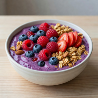 Berry smoothie bowl with fresh fruits and granola topping