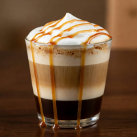 Caramel macchiato with caramel drizzle in a glass cup